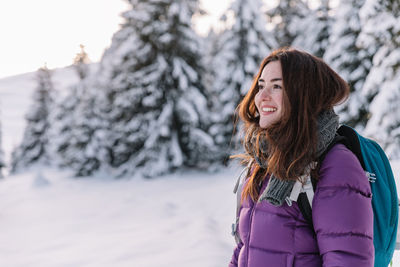 Young woman standing on snow