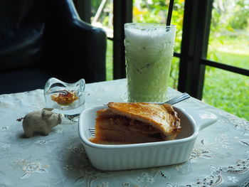 Close-up of apple pie and ice green tea on the table