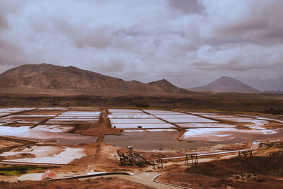 Scenic view of salt lakes and mountains against sky