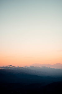 Scenic view of silhouette mountains against sky at sunset