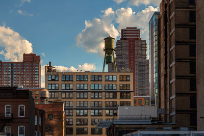 Low angle view of buildings against cloudy sky