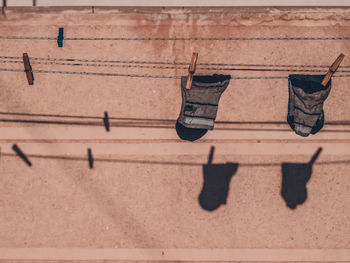 Socks drying on clothesline against wall