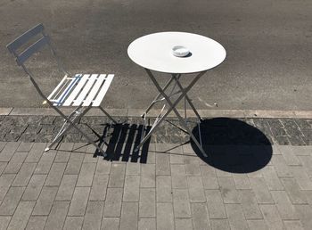 High angle view of empty bench on street