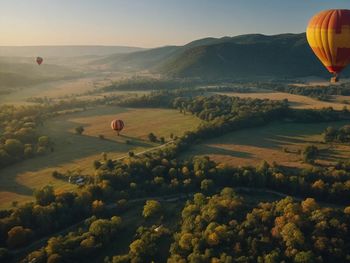 Hot air balloons against sky during sunset