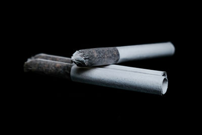 Close-up of cigarette against black background