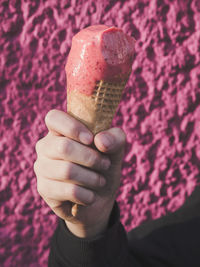 Close-up of hand holding ice cream cone