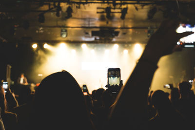 Group of people photographing at music concert