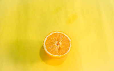 Close-up of lemon slice against yellow background