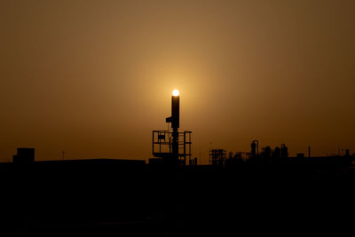 Silhouette building against sky during sunset