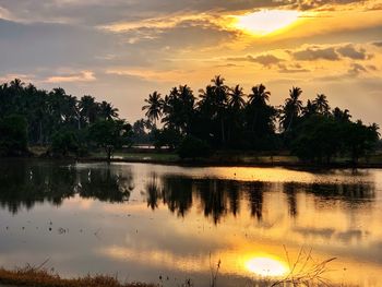 Scenic view of lake against sky during sunset