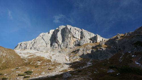 Scenic view of mountains against blue sky