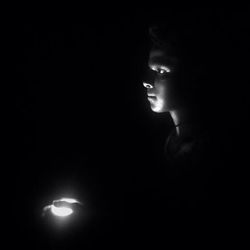 Portrait of man against black background