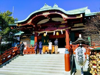 People at temple against clear sky