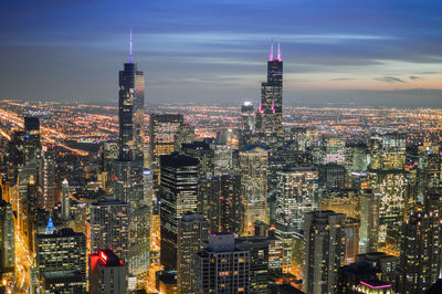 High angle shot of illuminated cityscape against sky