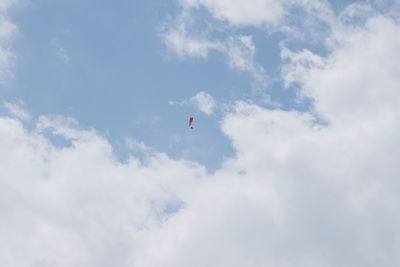 Low angle view of paragliding against sky