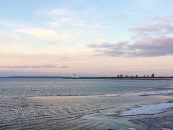 Scenic view of beach against sky during sunset