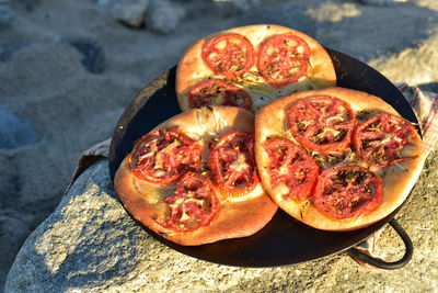 Baked italian focaccia bread topped with tomato slices