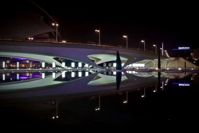 Illuminated bridge in city at night