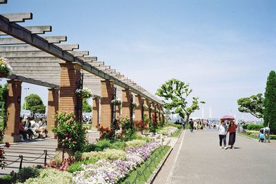 People walking on pathway by built structure