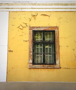 Low angle view of window on wall of building