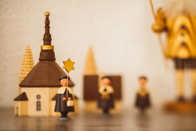 Close-up of figurine on table against building