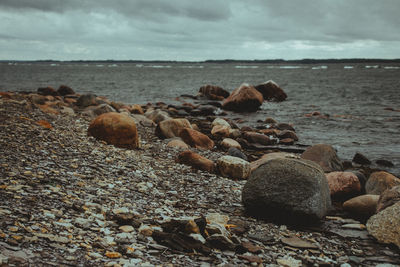 Pebbles on beach against sky