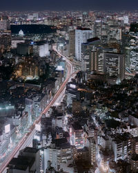 High angle view of illuminated city buildings at night