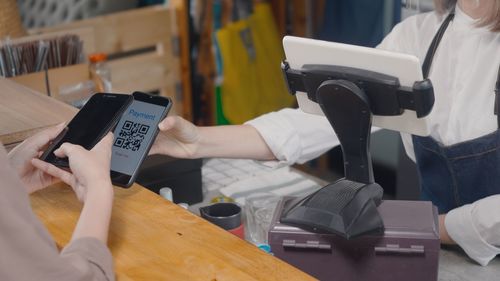 Midsection of man using mobile phone