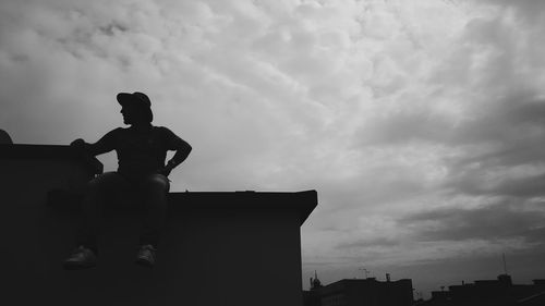 Silhouette of statue against cloudy sky