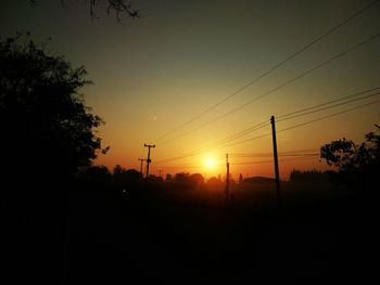 Silhouette trees against sky during sunset