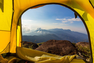 Scenic view of mountains against sky seen through window