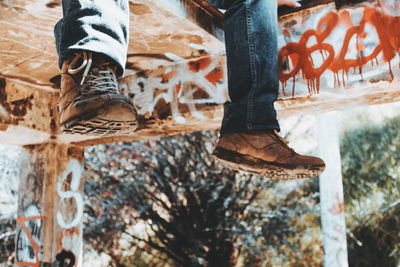 Low section of man standing on puddle