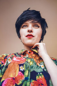 Smiling woman with make-up against colored background