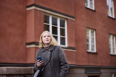 Woman using her cell phone while walking