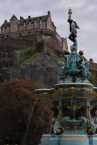 Low angle view of statue against historic building