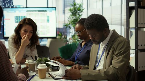 Side view of woman using mobile phone while sitting on table