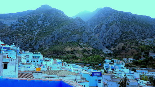 Scenic view of mountains against blue sky