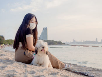 Portrait of young woman sitting on beach