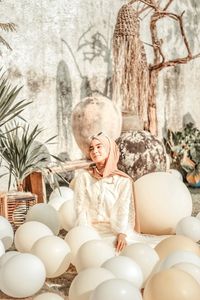 Woman sitting by plants