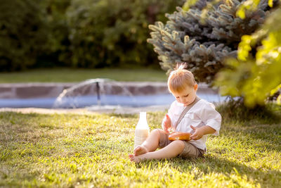 Cute girl sitting on field