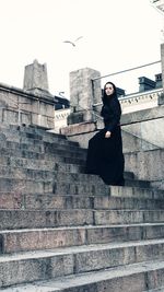 Full length portrait of woman against sky