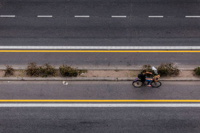 High angle view of woman riding bicycle on road