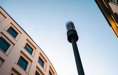 Low angle view of street light against building