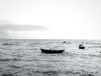 Boat sailing in sea against sky