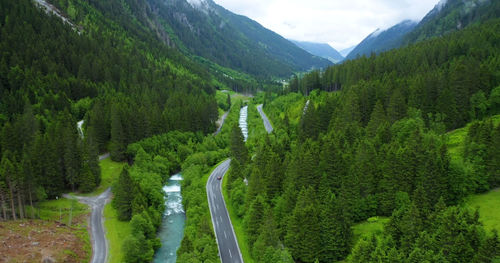 Panoramic view of road amidst trees and mountains