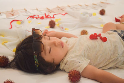 Close-up of young woman sleeping on bed at home