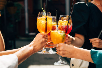 Friends toasting with summer cocktails
