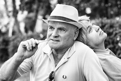 Portrait of man with woman wearing hat