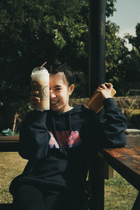 Man and smiling boy sitting outdoors