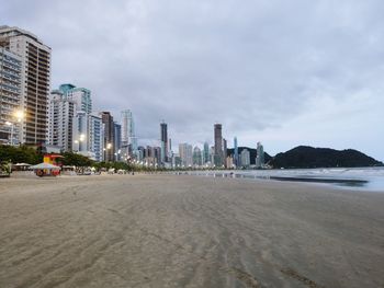 View of beach and buildings against sky